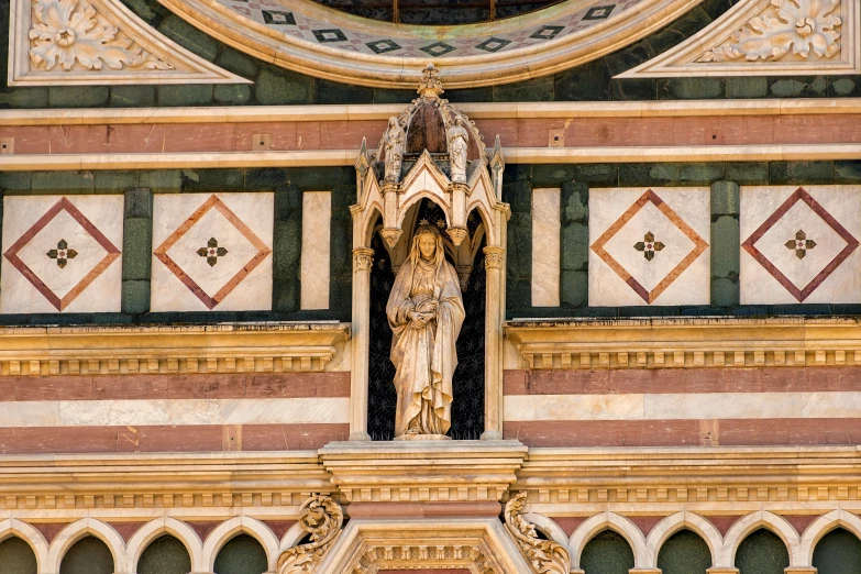 an elaborate looking building with decorative stonework and stained glass