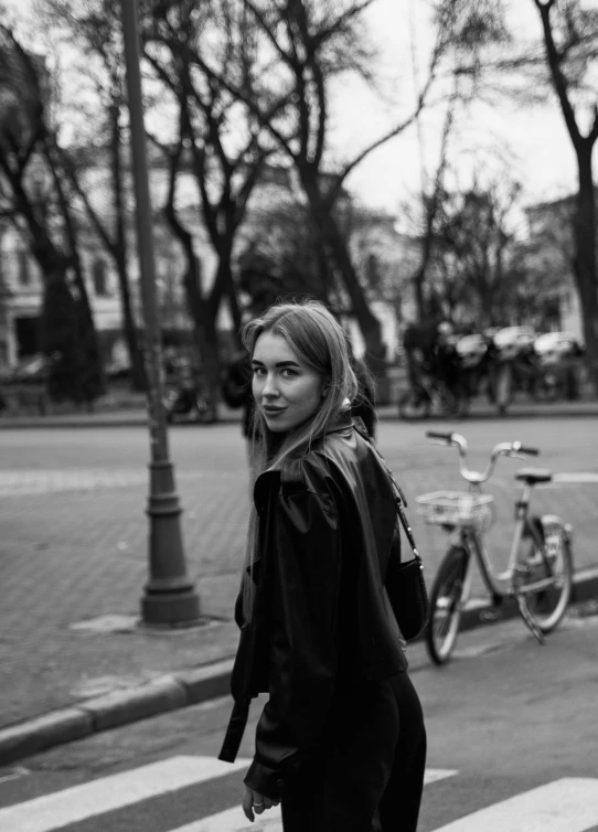 a girl wearing black and white crossing the street