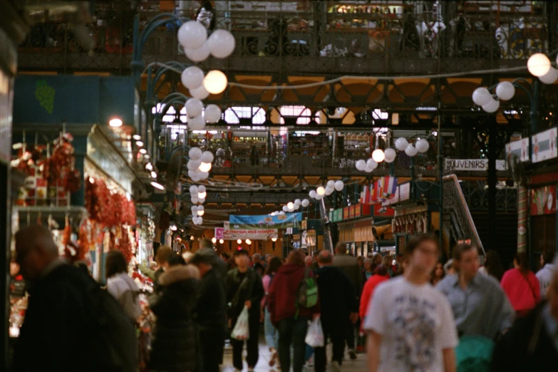 a crowded market with lots of people shopping