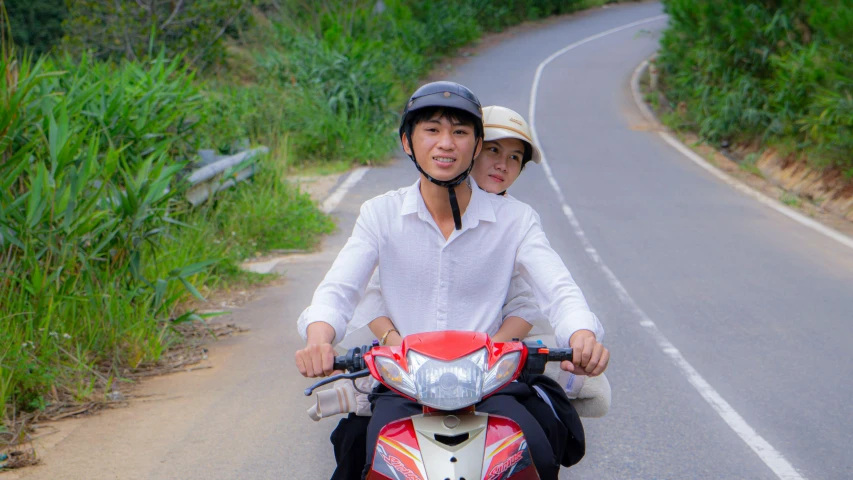 a man and woman on a motor cycle