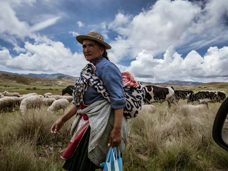 a woman with several bag walking in an open field