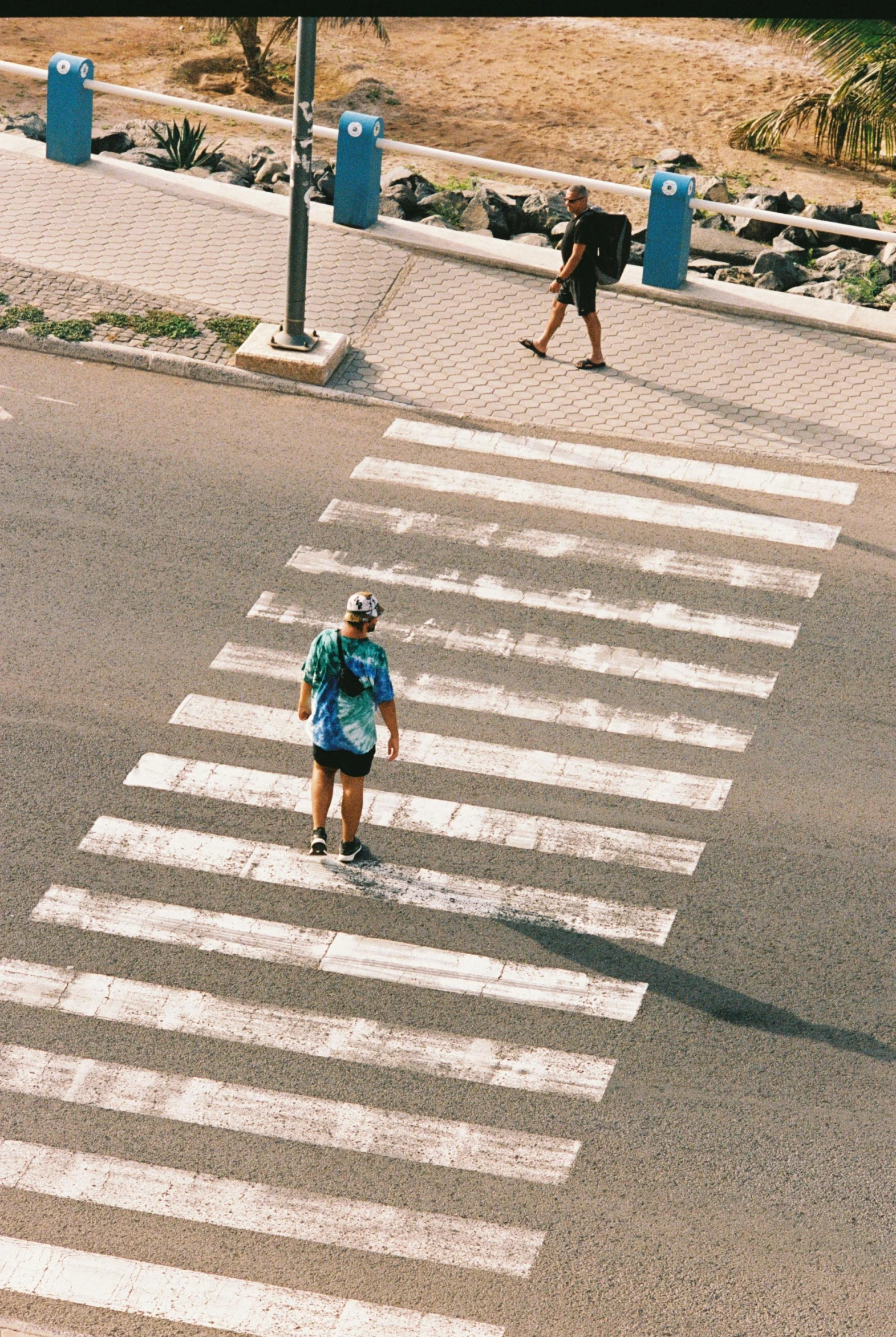 a person on a skateboard riding across the street