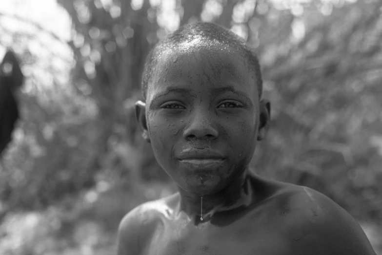 an african american boy posing for a picture with his nose in the foreground