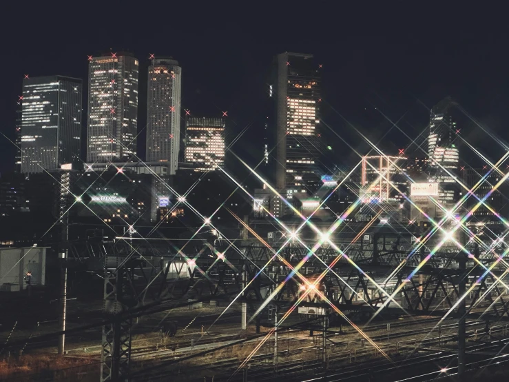 a city with lights and rails in front of it