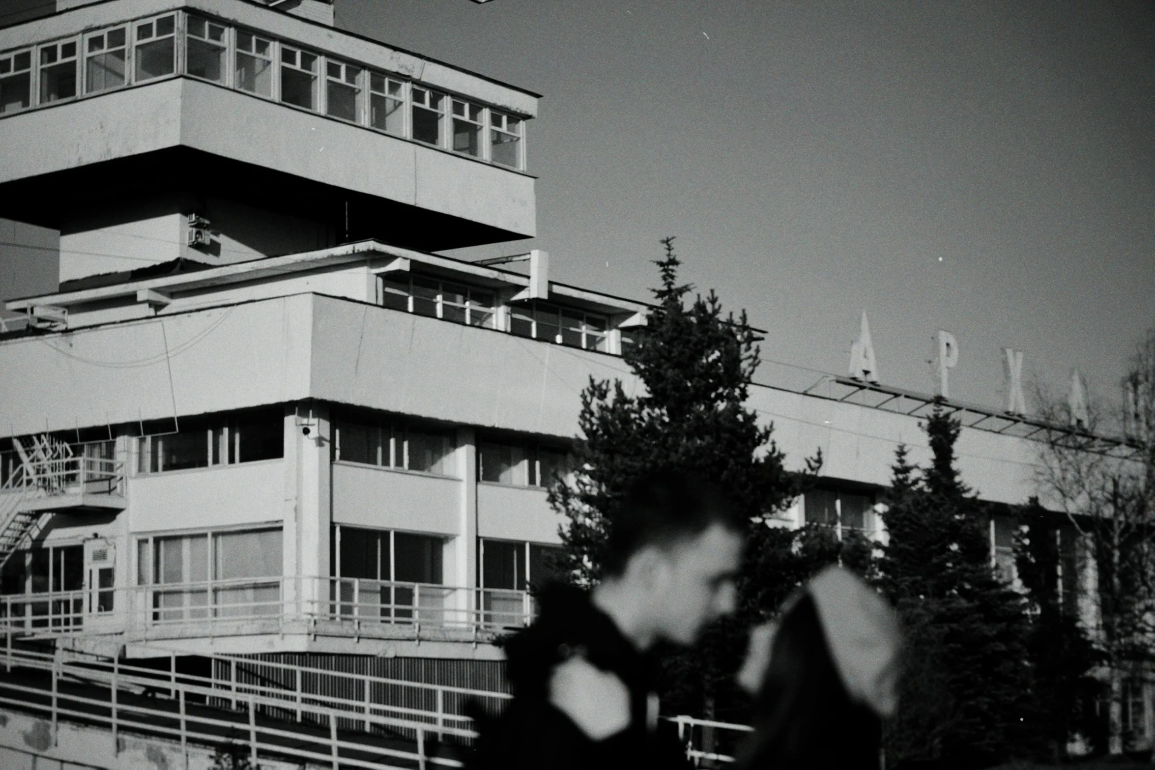 two people stand in front of a building