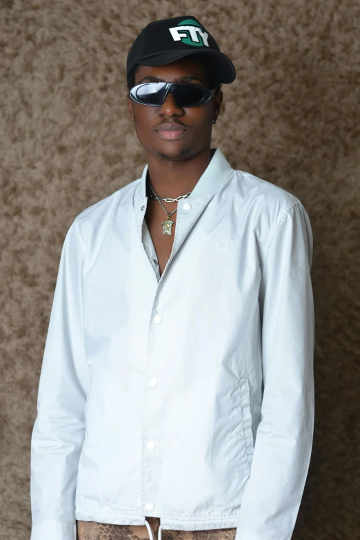 a man wearing sunglasses and a white shirt