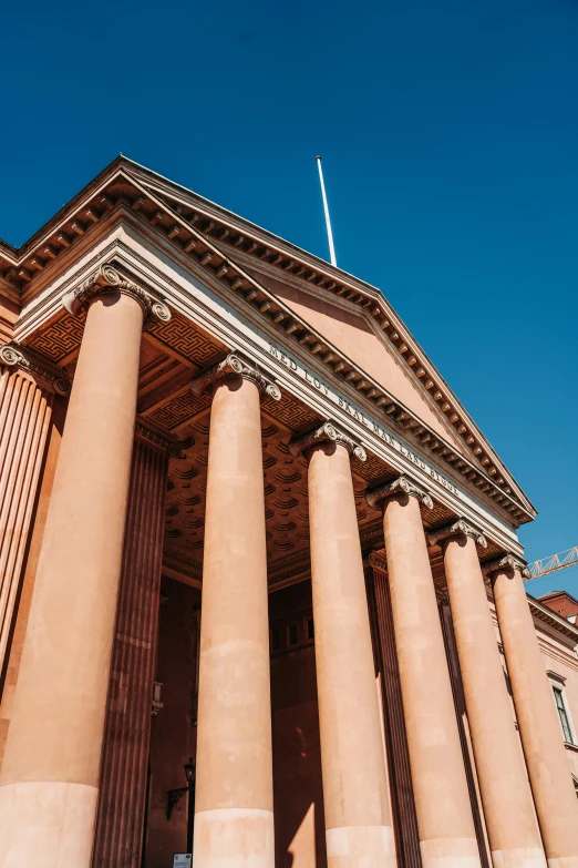 a large building with four columns that are sitting outside