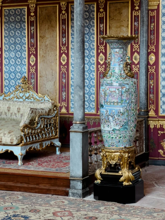 an ornate room with two fancy blue and gold urns