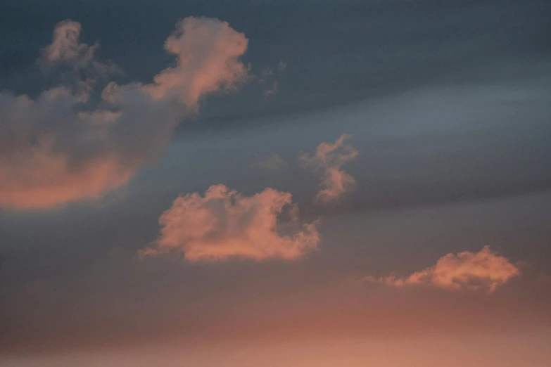 the silhouette of a cloud in a bright pink sunset