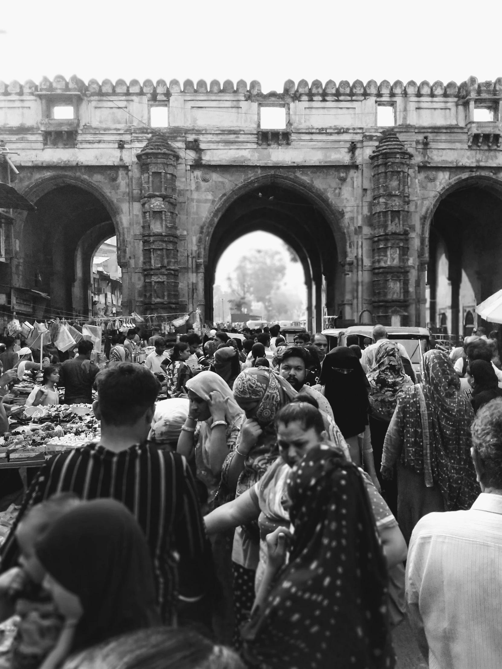 people gather in a plaza to sell things