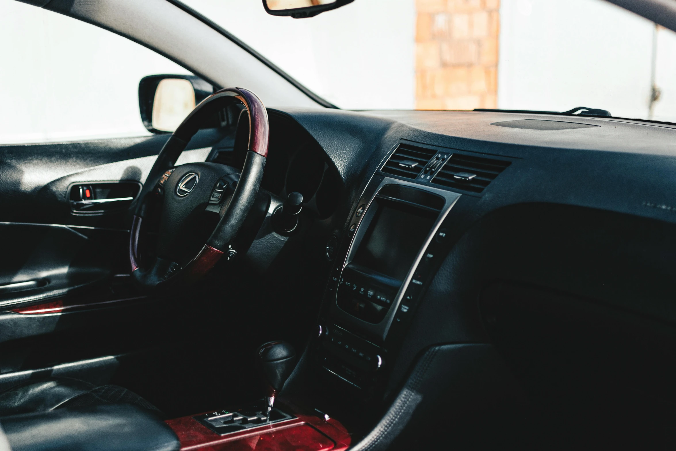 the inside of a car that is red and black