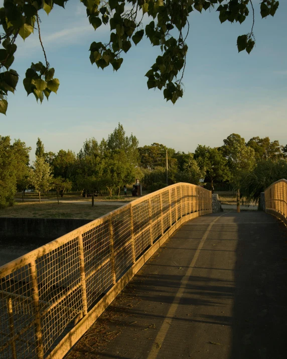 a bridge made of wood, with a fence on top