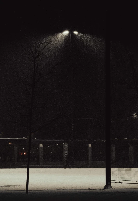 a bench in the dark at night under a light post