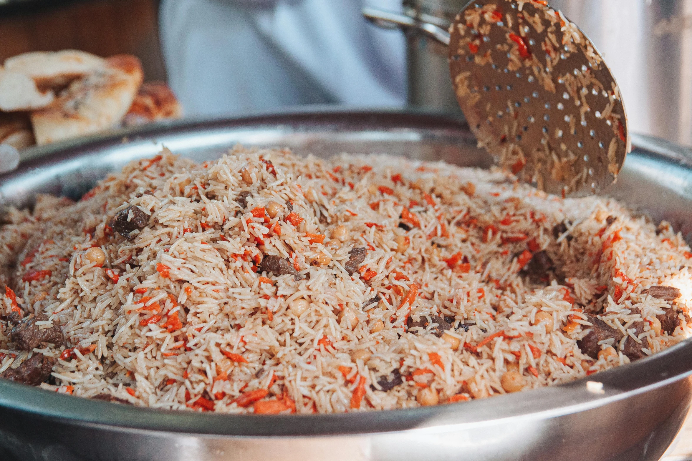 a steel container filled with rice, a sprinkle on top