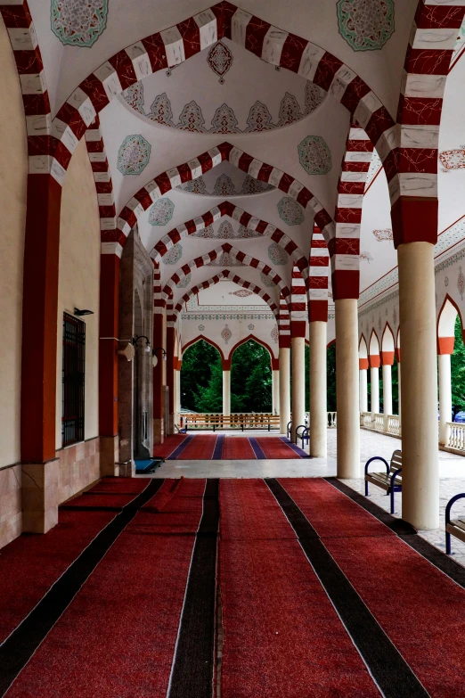 a large corridor with arches and tile ceiling