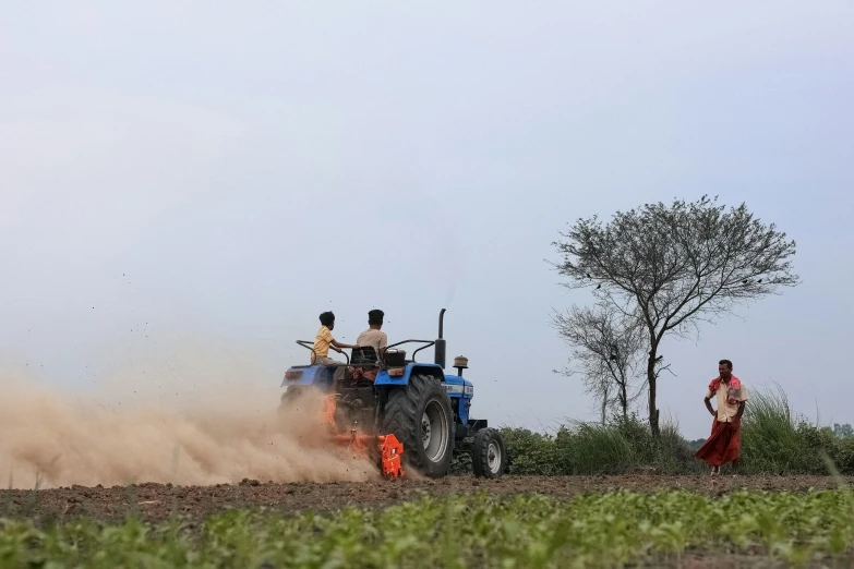 people and their tractors plowing the fields