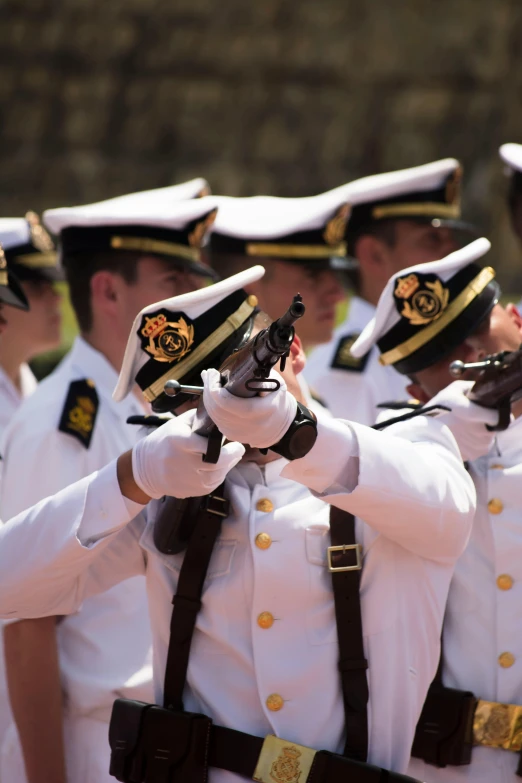 a group of people in uniform are performing in a parade