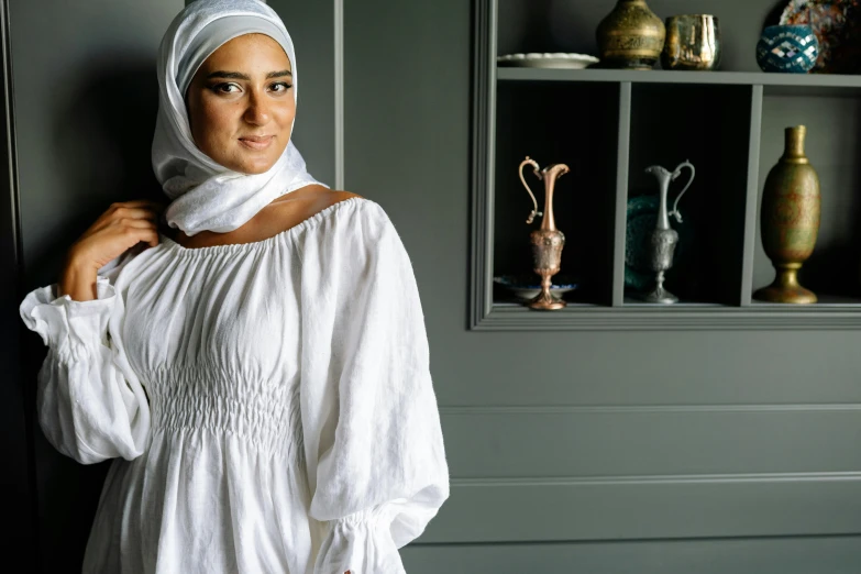 a woman poses in a dress made from linen