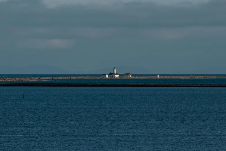 the lighthouse is on a light house stand in the middle of the ocean