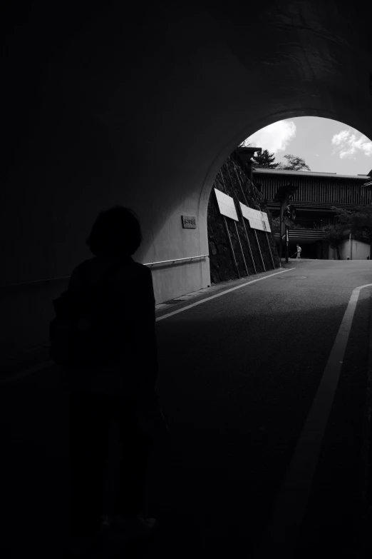 a dark tunnel leading to another building and the floor