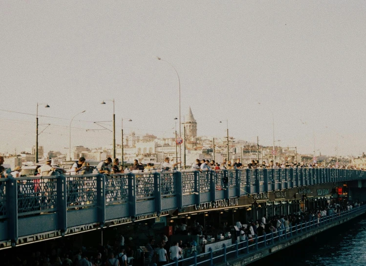 people on the side of a pier watching soing