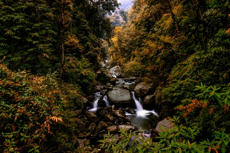 a river is surrounded by large rocks with water flowing