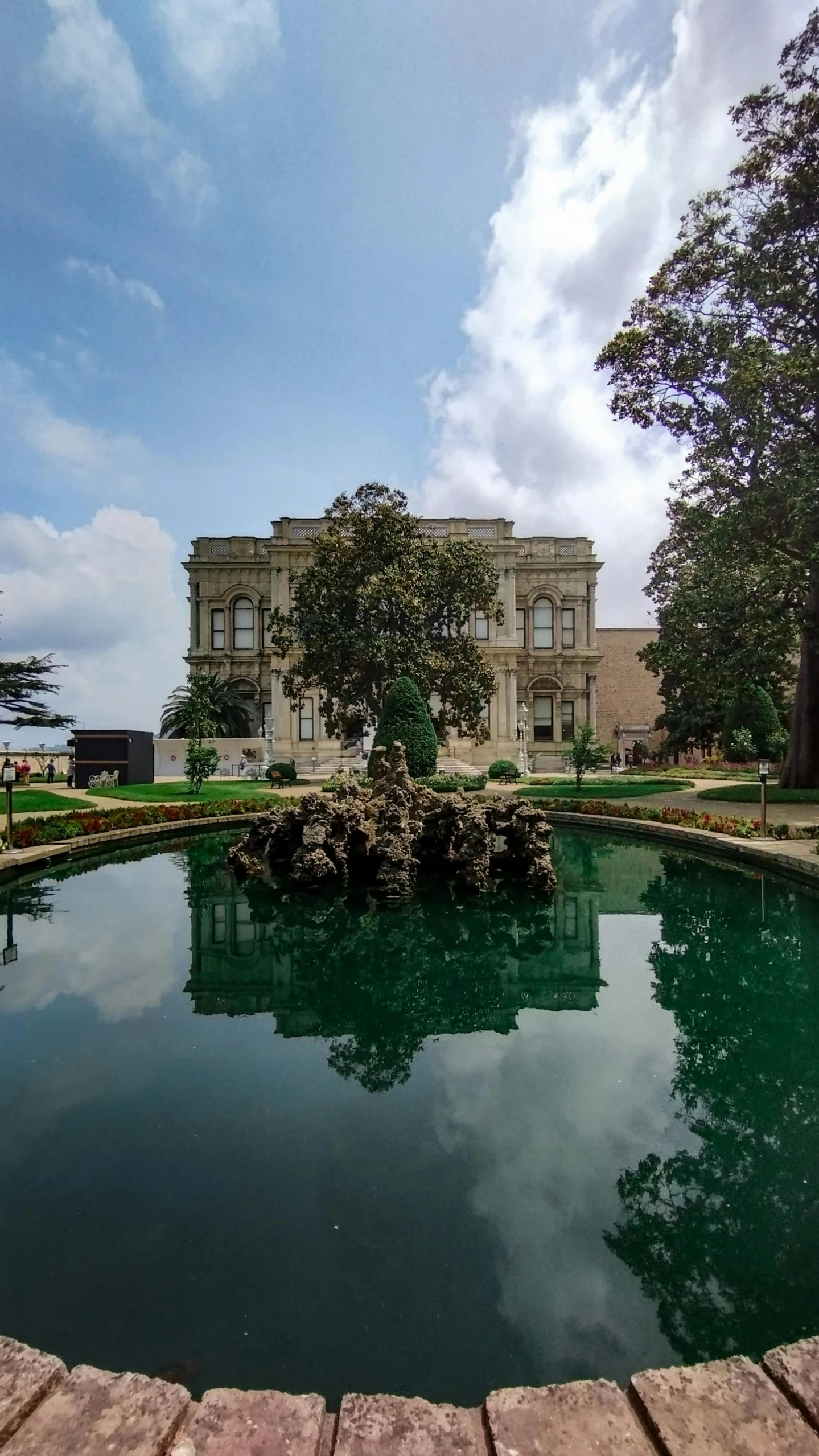 a building sits next to a pond on the ground