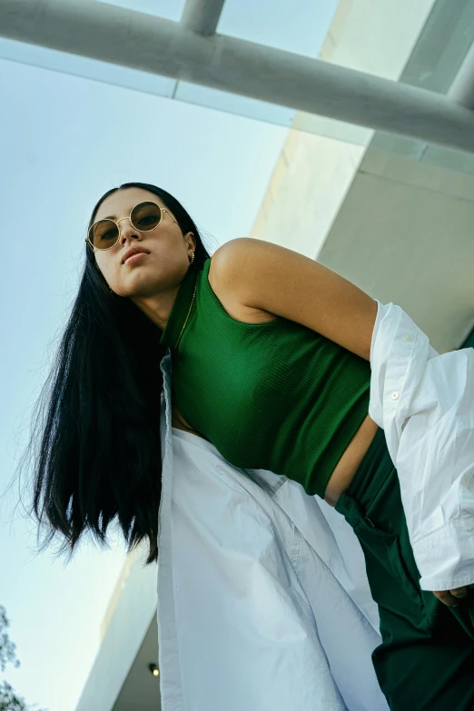 a young woman laying in bed wearing sunglasses