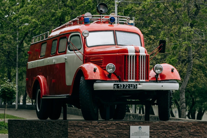 an old school bus sitting on top of a brick wall