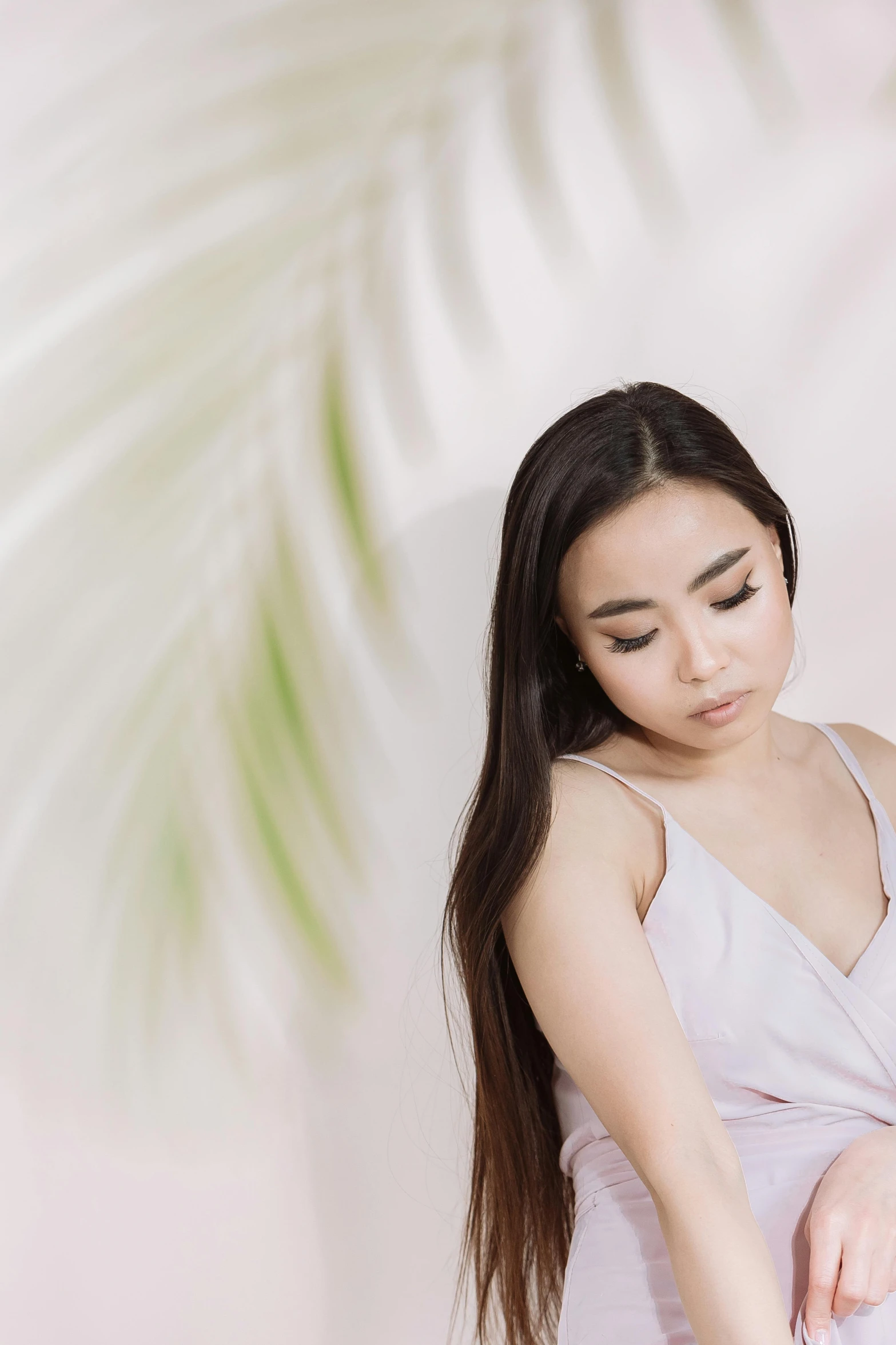 a woman in a white dress has long dark hair