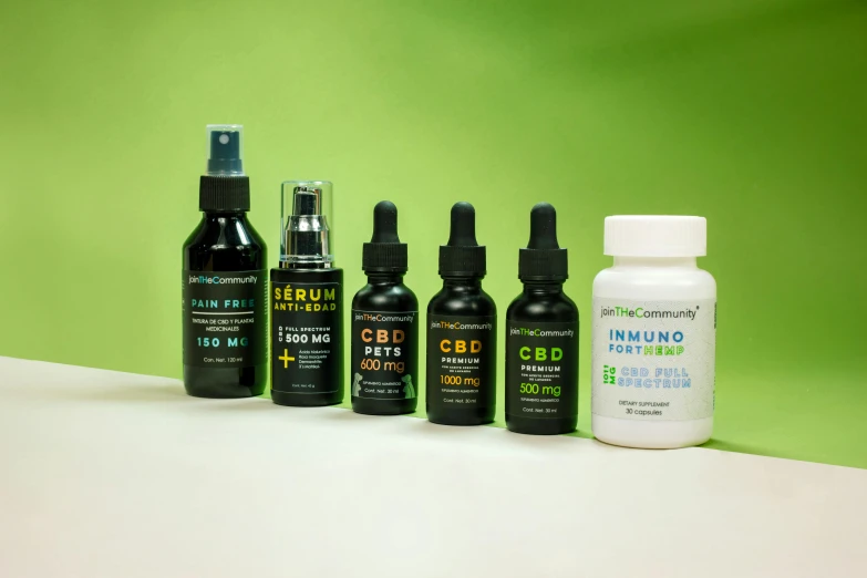 six bottles of cbd oil lined up on a counter