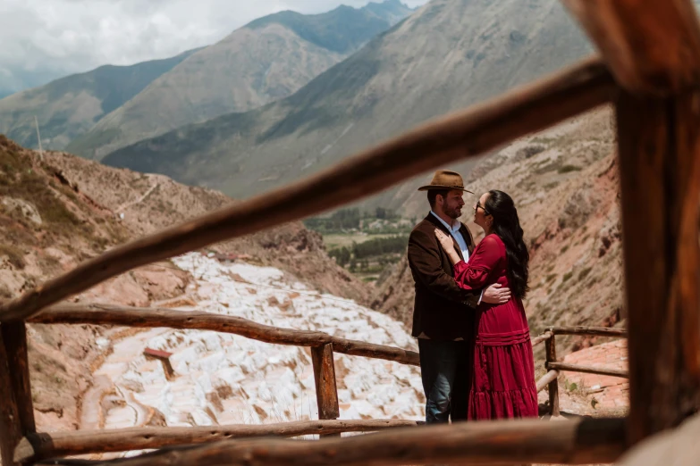 a couple emce in front of mountains with snow