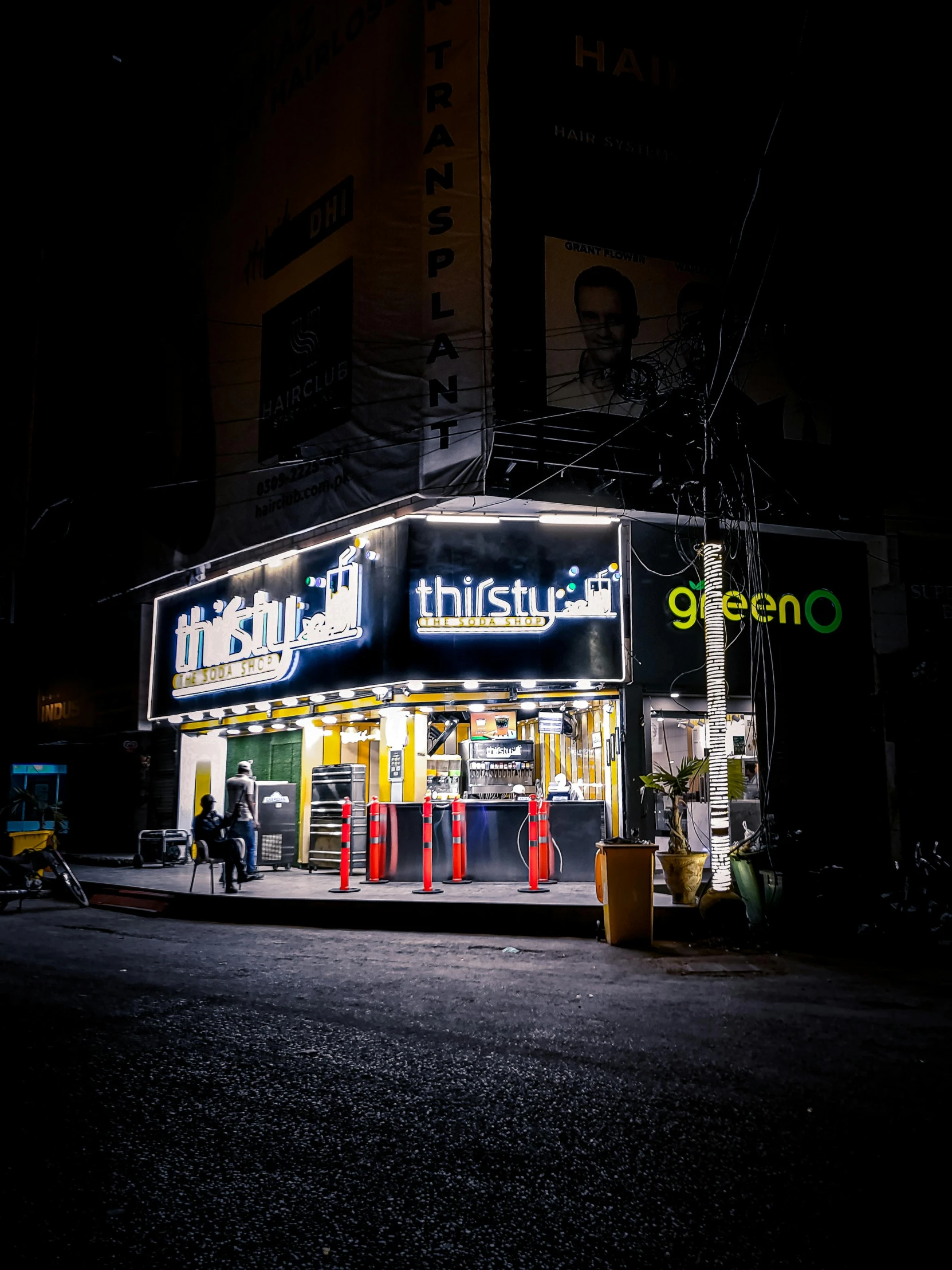 a restaurant lit up at night with the neon signage