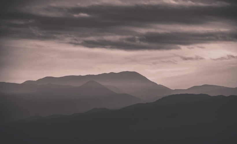 the view from a distance of a landscape with mountains