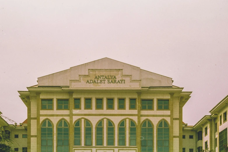 the front entrance to a building with green doors