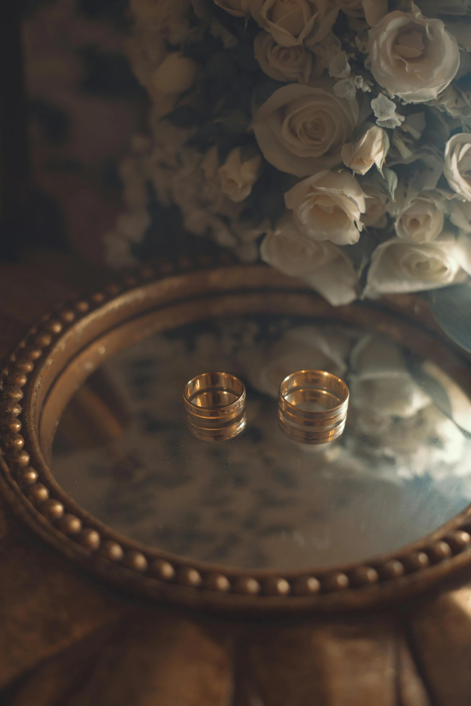 wedding rings on a tray near flowers