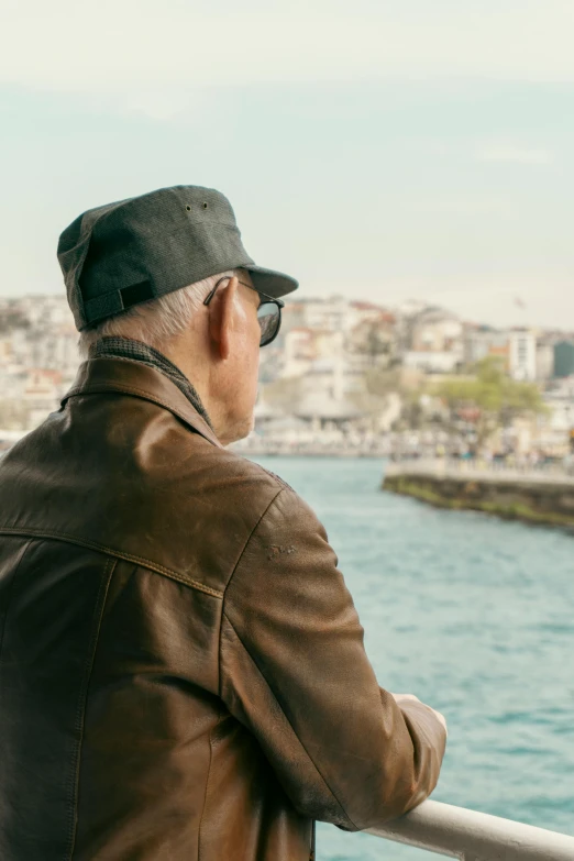 a man looking out at the ocean from a balcony