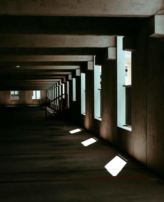 a long dark hallway lined with multiple windows