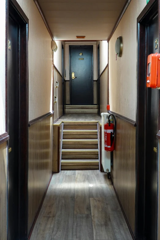 a long hallway with stairs leading to another set of stairs