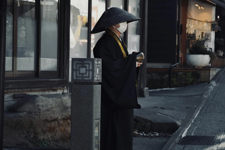 an elderly woman with a mask on holding a cup of coffee