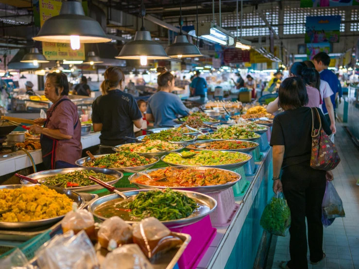 a large group of people looking at food