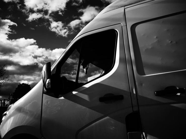 black and white po of a van with the sun shining down on it