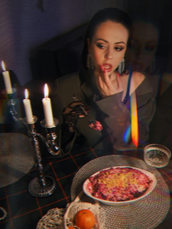 the woman is eating dinner with her tongue out