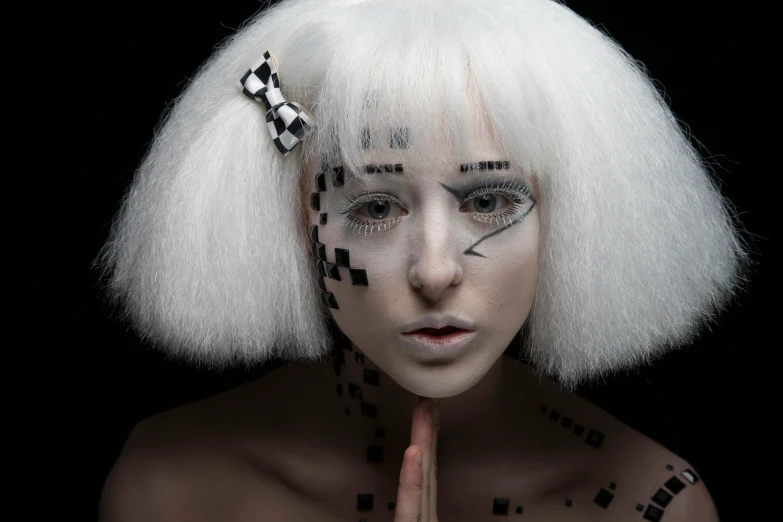 a woman with white hair and cross - design tattoos