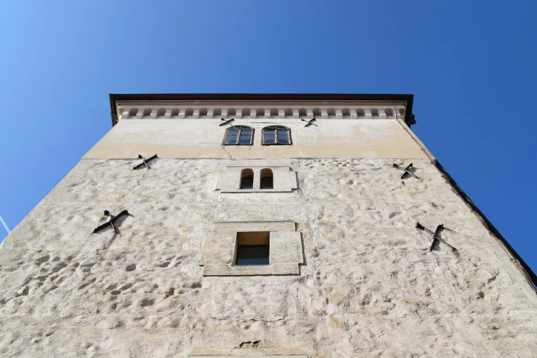 a tall clock tower with several windows next to it