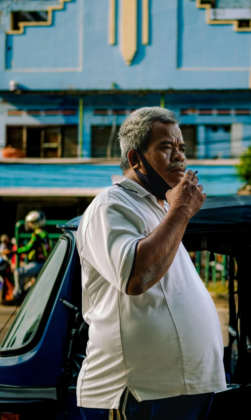 a man is talking on his phone by his car