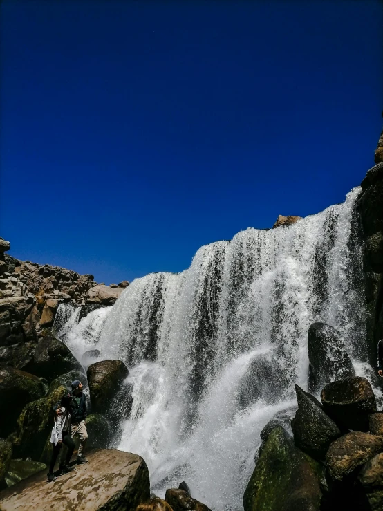 a waterfall being ridden on a motor bike