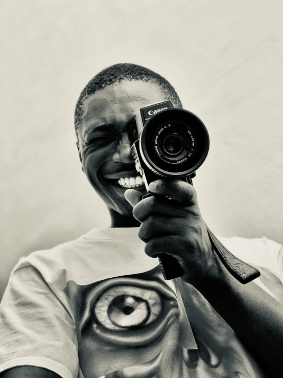 an image of a smiling man with a camera