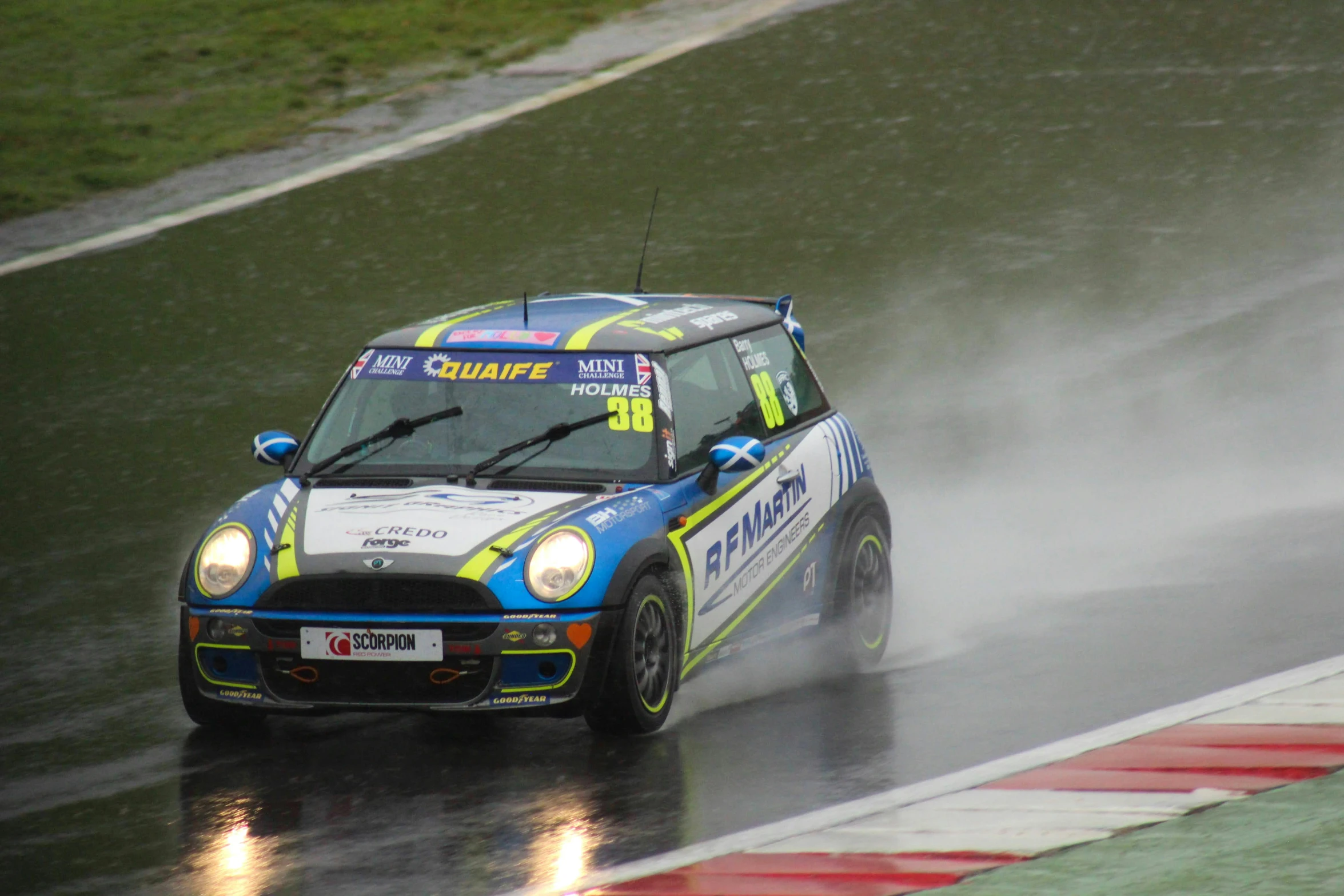 a race car driving on a wet road