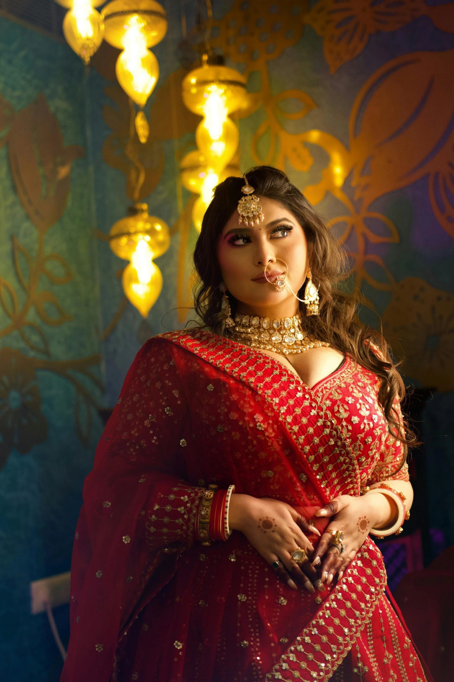 a woman wearing a red sari posing for the camera